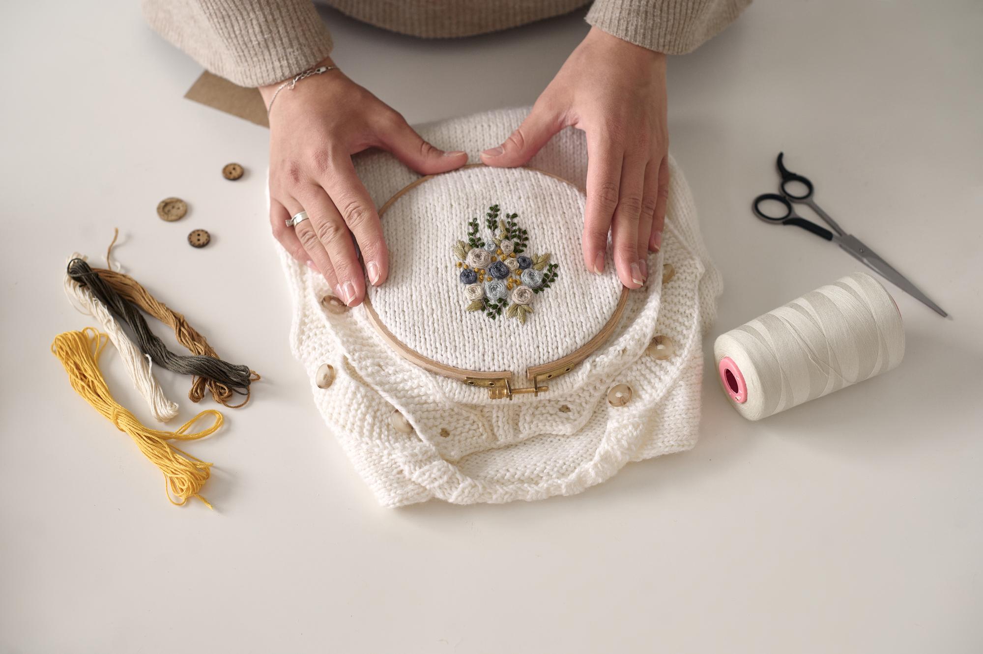 close-up of hand embroidery on linen, warm tones